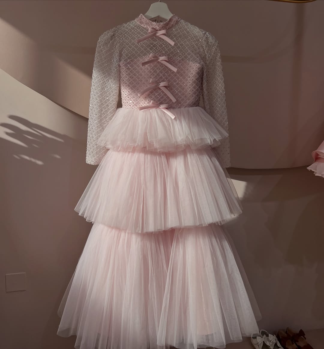 Delicate and elegant baby dress crafted in soft blush pink tones